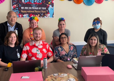 A group of employees sitting at a table together at Willows Post Acute.