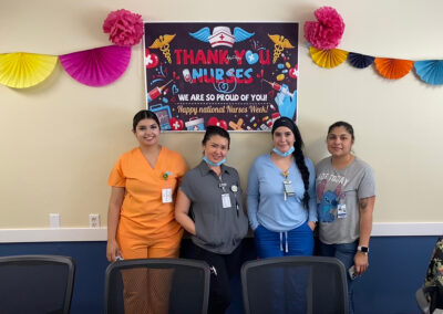 Four nurses standing in front of a sign that says thank you nurses at Willows Post Acute