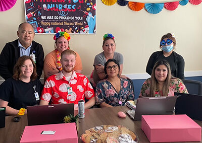 A group of employees sitting at a table together at Willows Post Acute.